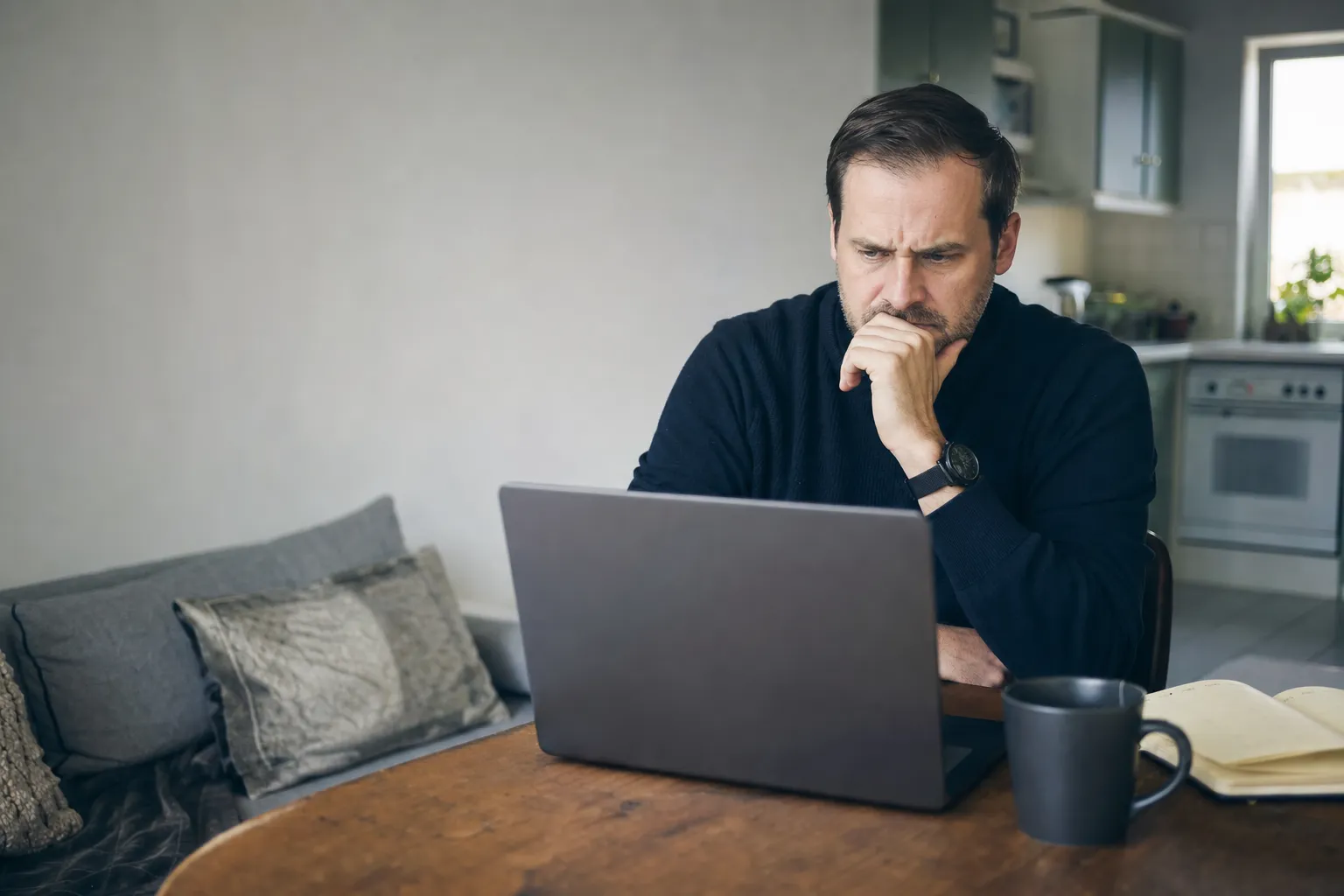 Someone reading a trading claim on a laptop, unconvinced